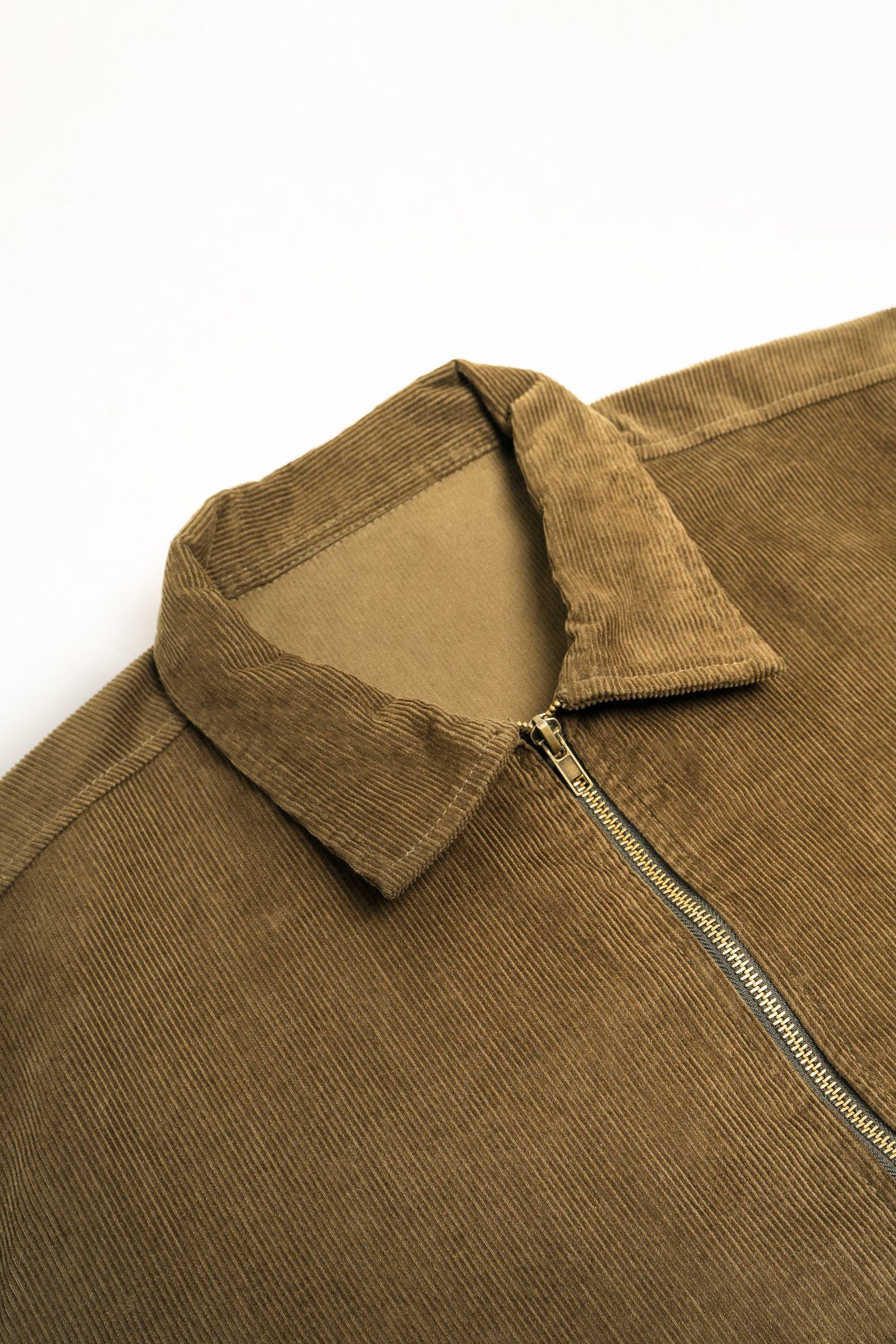 Close view of the olive corduroy collar and zip