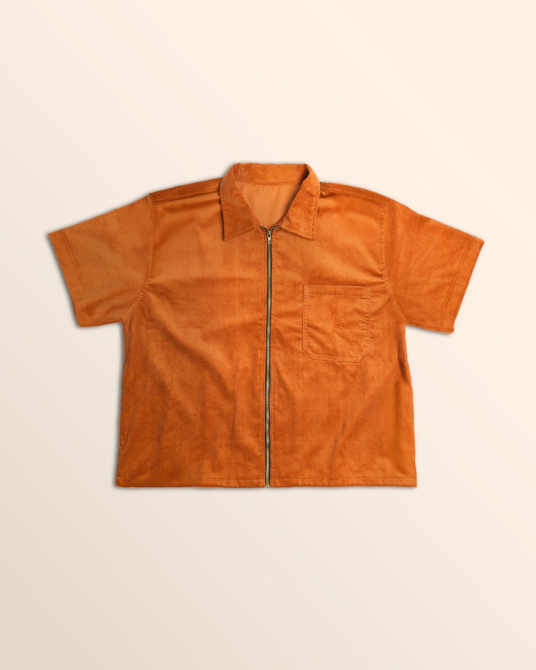 Rust workshirt laid flat with a chest pocket and full zip