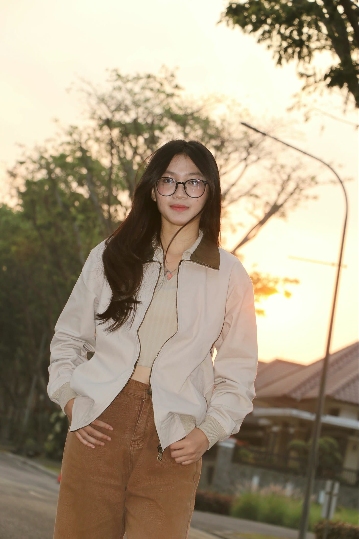 Model in the broken white zipper jacket at sunset, hands in pockets